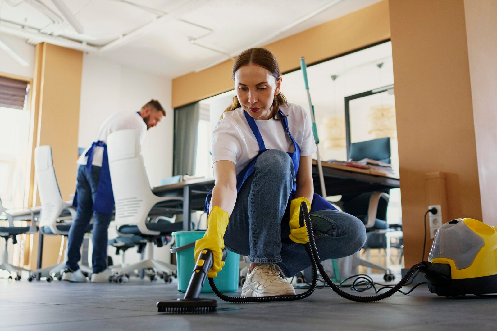 professional cleaning service person using vacuum cleaner office